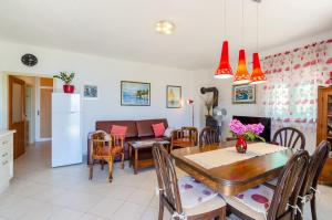 a dining room and living room with a table and chairs at Vacation House Marija, Korčula in Korčula