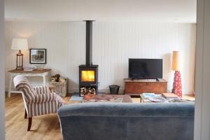 a living room with a couch and a fire place at The Workshop in Fakenham