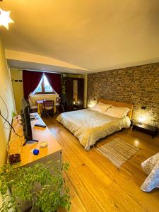 a bedroom with a bed and a brick wall at BellaVista in Popoli