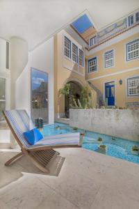 a chair in front of a house with a swimming pool at Solar do Castelo - Lisbon Heritage Collection - Alfama in Lisbon