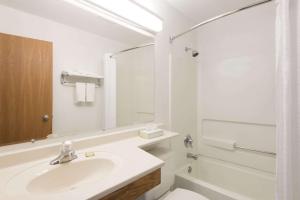 a white bathroom with a sink and a toilet at Super 8 by Wyndham New Stanton in New Stanton
