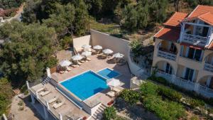 an aerial view of a house with a swimming pool at Mazis Apartments in Agios Gordios