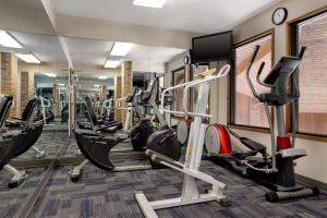 a gym with treadmills and elliptical machines at Baymont by Wyndham Monroe in Monroe