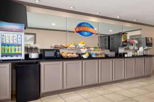 a fast food restaurant with a counter with food at Baymont by Wyndham Monroe in Monroe