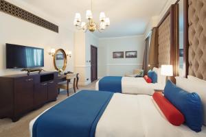 Postel nebo postele na pokoji v ubytování Dukes The Palm Dubai Hotel