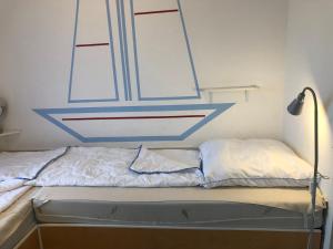 a bed in a room with a blue and white ceiling at Vier Jahreszeiten 6-4 in Großenbrode