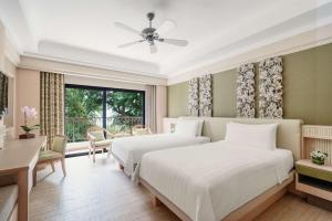 Cama ou camas em um quarto em Shangri-La Rasa Sentosa, Singapore