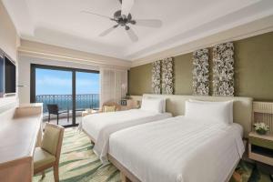 Cama ou camas em um quarto em Shangri-La Rasa Sentosa, Singapore