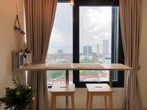 a large window with two stools in front of it at Tropicana 218 Macalister Netflix Seaview in George Town
