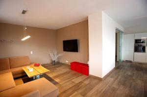 a living room with a couch and a table at Haus Clarysse in Schladming