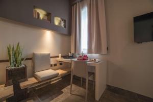 a living room with a table and a window at Best Western Plus Hotel Terre di Eolo in Patti