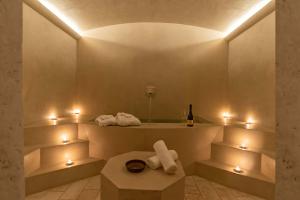 a bathroom with a tub with lights and a bottle of wine at Villa Cassia di Baccano in San Giustino Valdarno