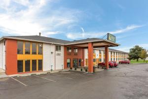 a building with a parking lot in front of it at Quality Inn Airport in Boise