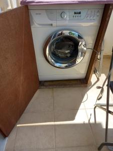 a washer and dryer sitting in a kitchen at Anastasia's Apartment 2 in N&eacute;a P&eacute;ramos
