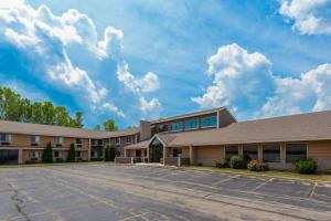 an empty parking lot in front of a building at AmericInn by Wyndham Hartford WI in Hartford