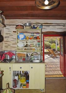 a kitchen with a counter and a sink in a room at Traditional stone house 1bedroom, sea view, Syros in Ano Syros