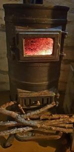 a brick oven with a red object in it at Traditional stone house 1bedroom, sea view, Syros in Ano Syros