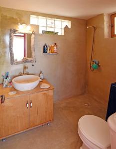 a bathroom with a sink and a toilet at Traditional stone house 1bedroom, sea view, Syros in Ano Syros