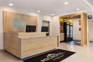 a lobby of a mcdonalds restaurant with a cash register at Microtel Inn Suites by Wyndham Lac-Megantic in Lac-Mégantic