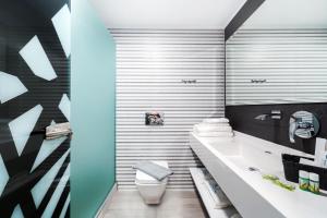 a bathroom with a white toilet and a sink at Studios Nautilus III in Potos +30 photos