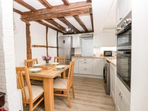 a kitchen with a wooden table and chairs at 36 High Street in Salisbury