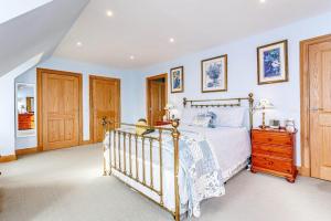 a bedroom with a bed and a wooden dresser at Glenerrick House - Loch Ness country manor - hot tub and sauna in Whitebridge