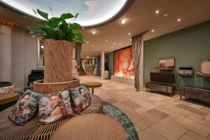 a living room with a couch with a plant on it at Hotel Sonne in Füssen