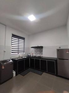 a kitchen with a sink and a refrigerator in a room at Free Disney Hotstar Private Pool Lotus Homestay Alor Setar for MUSLlM in Alor Setar