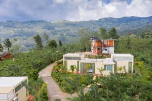 a house on top of a hill with trees at Nelinsa Resort and Spa in Matale