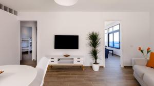 a living room with a tv on a white wall at Anaga Ocean Views (A): Mountain and Beach Retreat in Santa Cruz de Tenerife