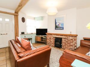 a living room with a couch and a fireplace at The Yellow House, 13 King Street in Dawlish