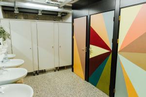 a bathroom with two sinks and a colorful wall at Ecomama in Amsterdam
