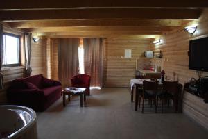 a living room with a couch and a table at Be-Taam Ahava Suites in Bruchim Qela' Alon