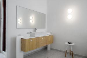 a bathroom with a sink and a mirror at Alkistis Beach Hotel - Adults Only in Agios Stefanos