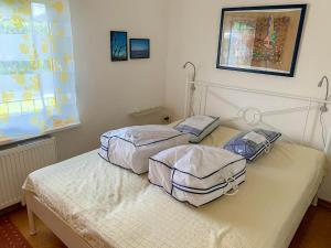 two twin beds in a room with a window at Ferienbungalow 182 in Stahlbrode