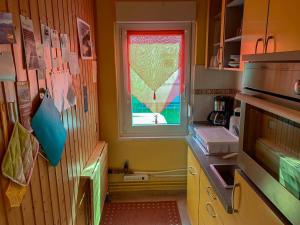 a small kitchen with a window and a counter at Ferienbungalow 182 in Stahlbrode