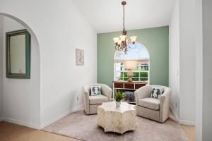 a living room with two chairs and a table at Tahiti House in Marco Island