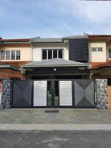 a house with black and white doors in front of it at PKA Residence at Taman Bentong Makmur in Bentong