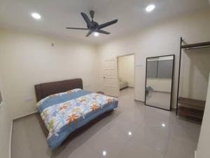 a bedroom with a bed and a ceiling fan at PKA Residence at Taman Bentong Makmur in Bentong
