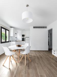 a kitchen and dining room with a white table and chairs at Anaga Ocean Views (A): Mountain and Beach Retreat in Santa Cruz de Tenerife