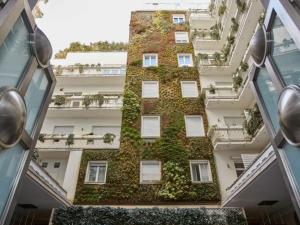 an apartment building with ivy on the side of it at Palazzo Beltrade in Milan