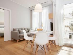 a dining room with a table and chairs and a couch at Palazzo Beltrade in Milan
