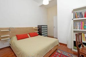 a bedroom with a bed and a book shelf at Tirso in Rome