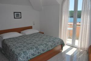 Postel nebo postele na pokoji v ubytování Hotel Carmen