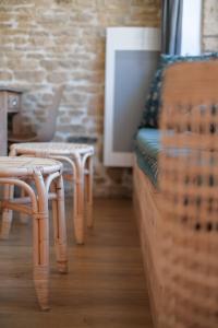 a group of chairs and a bed in a room at Le Domaine de l'Hostellerie in Le Fresne-Camilly