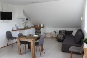 a living room with a table and a couch at Guesthouse Hateigi 3 in Hella
