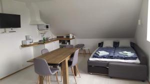a room with a bed and a table and chairs at Guesthouse Hateigi 3 in Hella