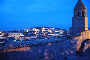 a view of a city at night with a tower at Residenza Ducale in Bovino