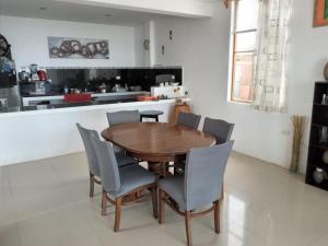 a wooden table and chairs in a kitchen at HOUSE WHITE VICHAYITO BEACH in Vichayito