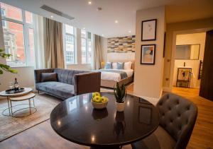 a living room with a table and a couch at The Gresham Aparthotel in Leicester